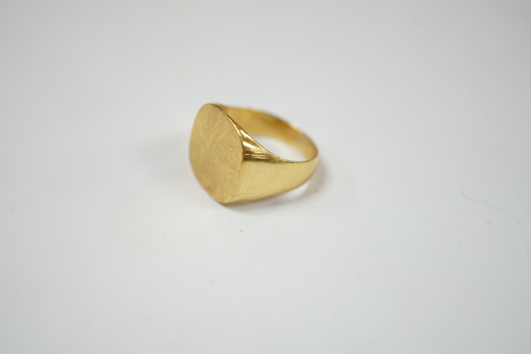A 750 yellow metal signet ring, size N